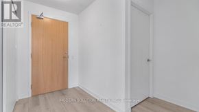 Toronto (Weston-Pellam Park) condo for rent - A room with a wooden door and a white wall.