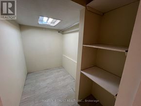 Mississauga (Erindale) apartment for rent - A small, empty room with a skylight and shelving units.