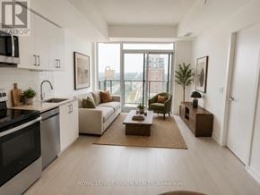 Toronto (Humber Heights) condo for rent - A modern kitchen with a dining area and a view of the city.