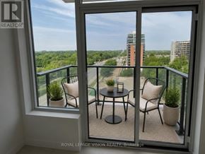 Toronto (Humber Heights) condo for rent - A balcony with a table and chairs overlooking a cityscape.