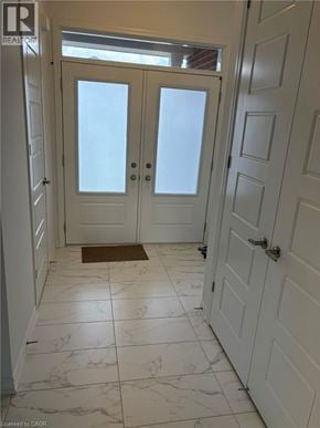 Kitchener townhouse for rent - A white door with a glass panel and a doorknob.