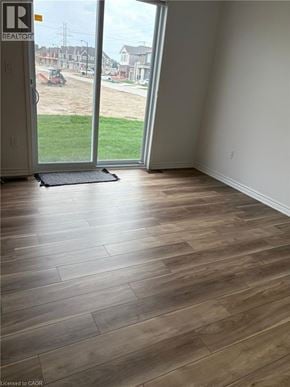 Kitchener townhouse for rent - A room with a wooden floor and a sliding glass door.