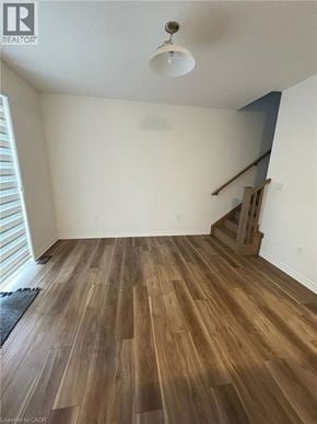 Kitchener townhouse for rent - A room with wooden flooring and a staircase.