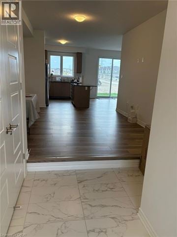 Kitchener townhouse for rent - A realtor's photo of a room with a kitchen and a dining table.