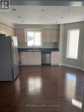 Barrie (Ardagh) apartment for rent - A kitchen with wooden floors and white appliances.