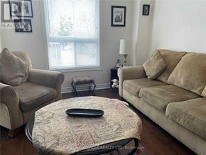 Barrie (Ardagh) apartment for rent - A living room with a couch, chair, ottoman, and lamp.