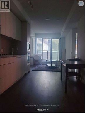 Toronto (Waterfront Communities) condo for rent - A modern kitchen with a dining table and chairs.