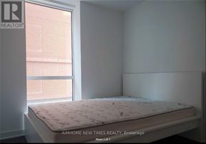 Toronto (Waterfront Communities) condo for rent - A bed with a white mattress is in a room with a window.