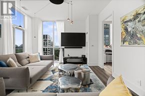 Toronto (Humewood-Cedarvale) condo for rent - A modern living room with a large flat screen TV and a view of the city.