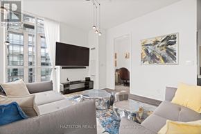 Toronto (Humewood-Cedarvale) condo for rent - A living room with a grey couch and a painting on the wall.