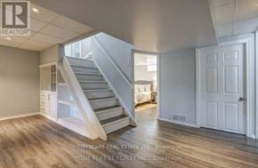 London East (East D) apartment for rent - A spacious room with a staircase leading to the upper level.