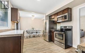 London East (East D) apartment for rent - A kitchen with a dining table and chairs in the background.