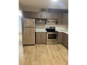 Langley apartment for rent - A kitchen with a stainless steel refrigerator and oven.