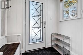 Brampton (Huttonville) apartment for rent - A white door with a glass panel and a metal handle.