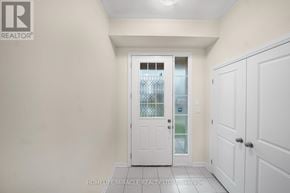 Loyalist (Bath) multi-family for rent - A white door with a glass window is in the middle of a hallway.