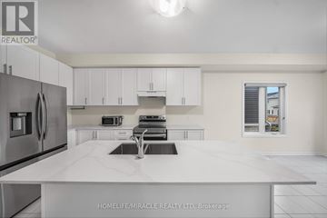 Loyalist (Bath) multi-family for rent - A modern kitchen with white cabinets and appliances.