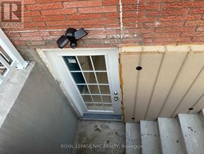 St. Catharines (Vine/Linwell) apartment for rent - A stairwell with a brick wall and a security camera.