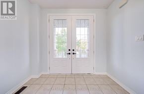 Newmarket (Woodland Hill) apartment for rent - A white door with a glass window is in the middle of a white room.