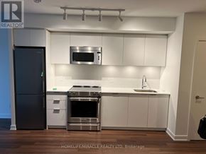 Toronto (Islington-City Centre West) condo for rent - A modern kitchen with white cabinets and stainless steel appliances.