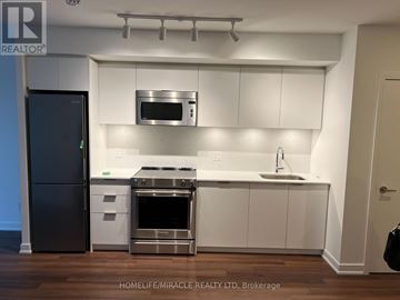 Toronto (Islington-City Centre West) condo for rent - A modern kitchen with white cabinets and stainless steel appliances.
