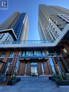 Vaughan (Vaughan Corporate Centre) condo for rent - A modern building with a glass facade and a sign that reads "HOMELIFE NEW WORLD REALTY INC.".