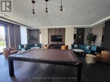 Vaughan (Vaughan Corporate Centre) condo for rent - A modern living room with a large table and a flat screen TV.