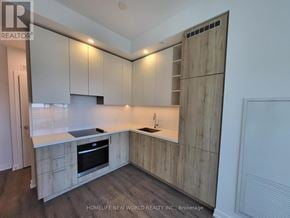 Vaughan (Vaughan Corporate Centre) condo for rent - A kitchen with wooden cabinets and a stove top oven.