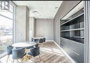 Toronto (Tam O'shanter-Sullivan) condo for rent - A modern dining room with a round table and grey chairs.