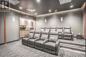 Toronto (Tam O'shanter-Sullivan) condo for rent - A home theater room with a row of grey recliner chairs.