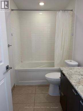 Toronto (Willowdale East) condo for rent - A white bathroom with a toilet, tub, and sink.