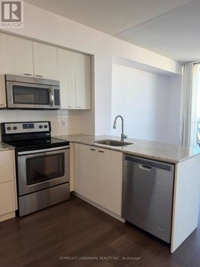 Toronto (Willowdale East) condo for rent - A kitchen with a stove, microwave, and dishwasher.