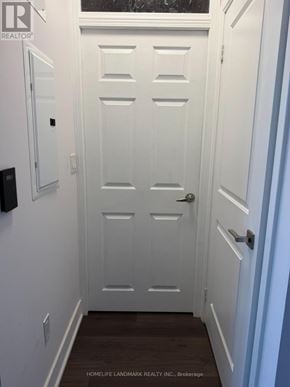 Toronto (Willowdale East) condo for rent - A white door with a handle and a small black box on the wall.