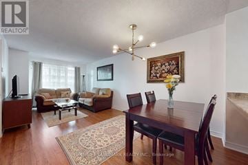 Toronto (Mount Pleasant West) condo for rent - A living room with a brown sofa set and a wooden dining table.