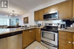 Toronto (Mount Pleasant West) condo for rent - A kitchen with wooden cabinets and stainless steel appliances.