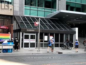Toronto (Annex) condo for rent - A subway station entrance with people walking by.