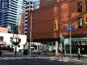 Toronto (Annex) condo for rent - A street corner with a traffic light and a building with a sign that says "Toronto".