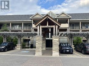 Collingwood condo for rent - A building with a carport and a black car parked in front.