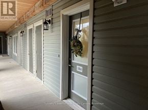 Collingwood condo for rent - A long hallway with a door numbered 104.