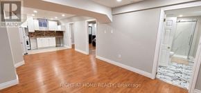 Mississauga (Lisgar) apartment for rent - A spacious room with wooden floors and white walls.