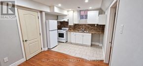 Mississauga (Lisgar) apartment for rent - A kitchen with white appliances and cabinets.