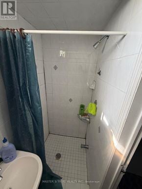 Markham (Milliken Mills West) apartment for rent - A bathroom with a white sink and a shower with a blue curtain.
