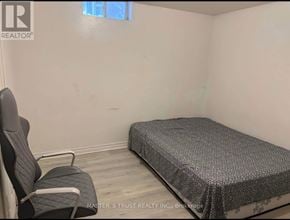 Markham (Milliken Mills West) apartment for rent - A bedroom with a bed, chair, and window.