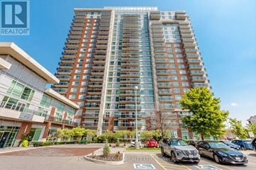 Brampton (Queen Street Corridor) condo for rent - A tall residential building with a parking lot in front.