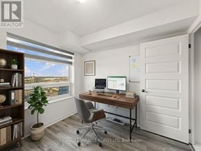 Brampton (Queen Street Corridor) condo for rent - A room with a desk, chair, and a window overlooking a body of water.