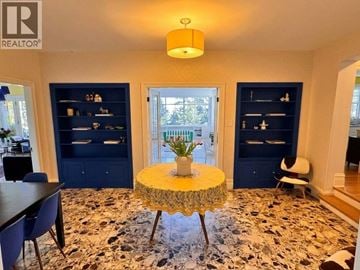 West Vancouver apartment for rent - A living room with a round table in the middle and a rug on the floor.