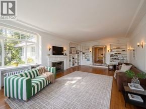 West Vancouver apartment for rent - A living room with a fireplace and a striped couch.