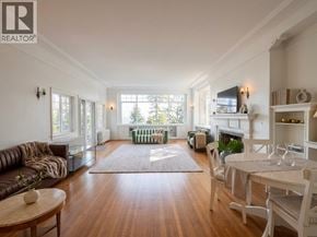 West Vancouver apartment for rent - A well-lit, spacious living room with a fireplace and a dining area.