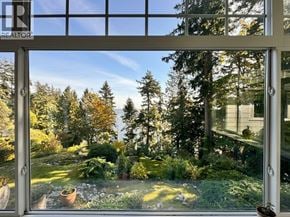 West Vancouver apartment for rent - A window with a view of a garden and trees.