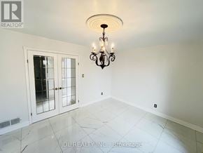 Whitby (Pringle Creek) apartment for rent - A chandelier hangs over a white marble floor in a room with white walls.