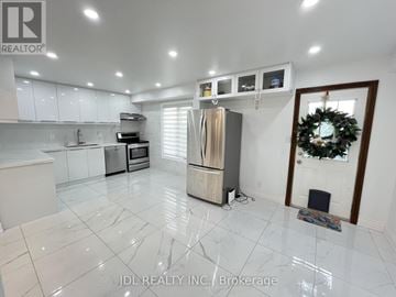 Whitby (Pringle Creek) apartment for rent - A kitchen with white cabinets and a marble floor.